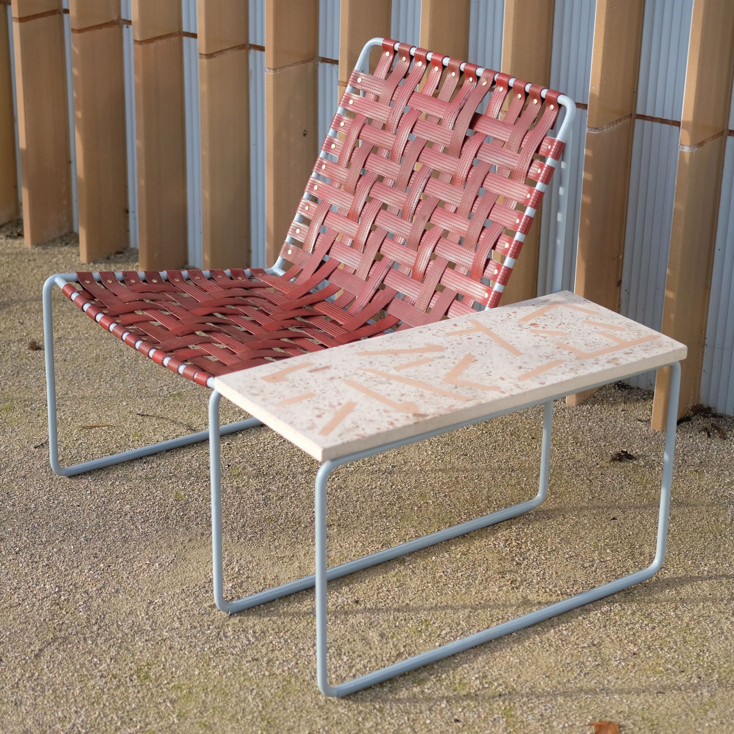 Woven red lounge chair with terrazzo sidetable by Local Works Studio