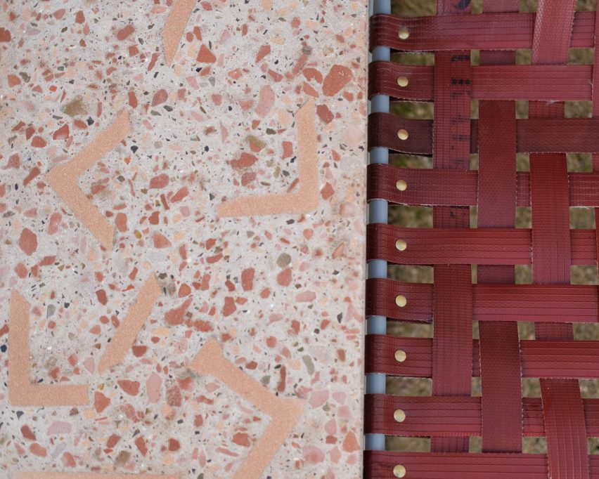 Close-up of terrazzo material next to woven red seat