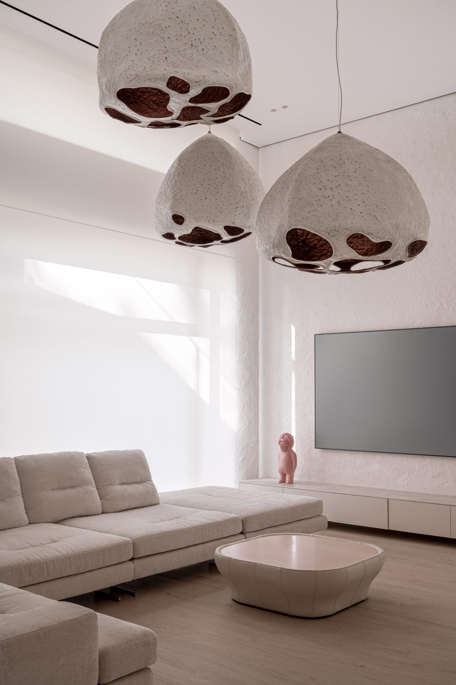 Living room of Mureli House with pendant light designed to look like seed pods
