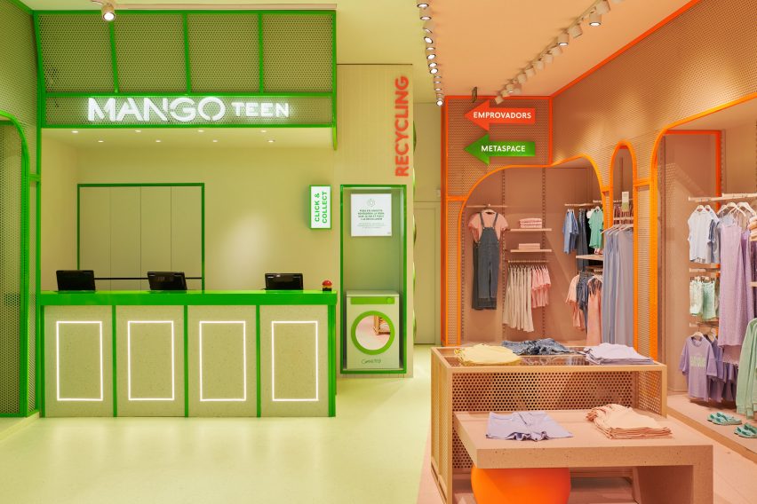 Green cash register and orange clothing display inside Mango Teen by Masquespacio