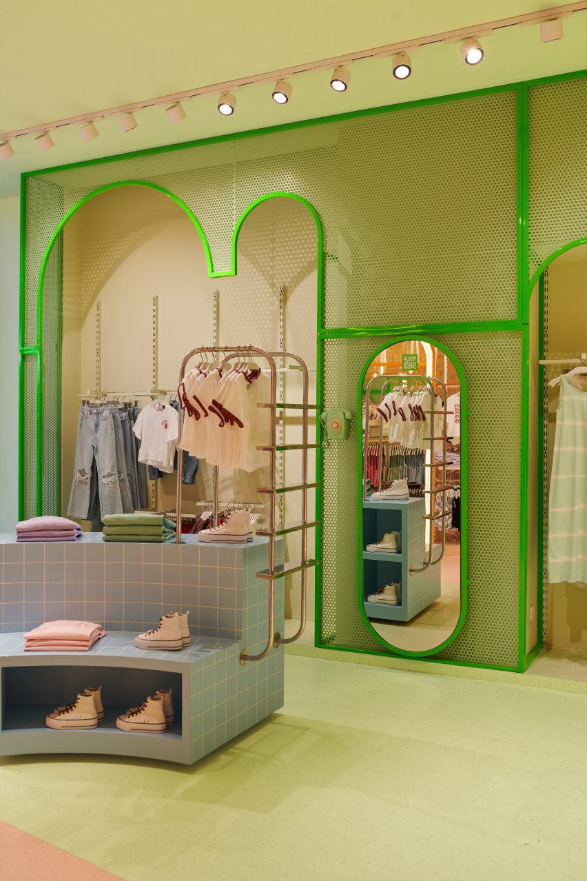 Green side of the Mango Teen shop interior with swimming pool-inspired clothing display