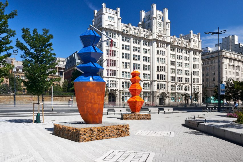Blue and orange sculptural towers sit in St Nicholas Place, Liverpool