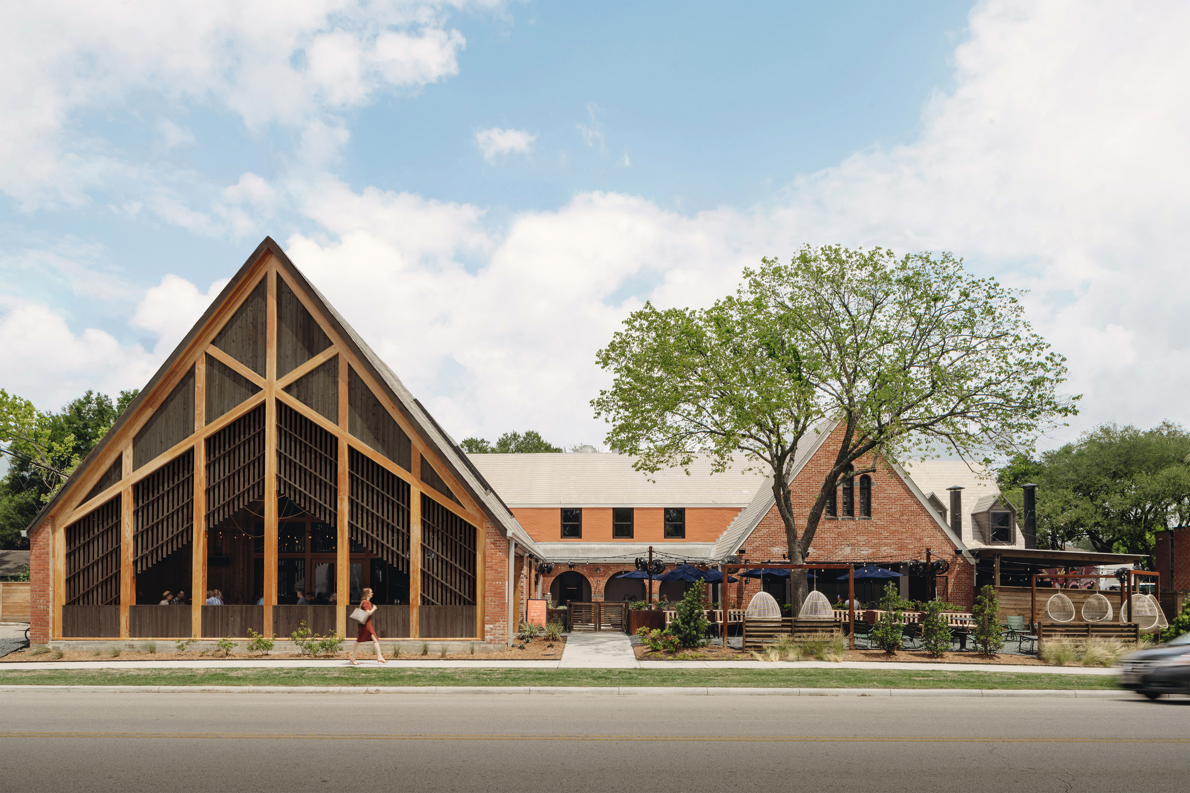 Exterior of gabled church with exposed timber structure converted into restaurant in Texas