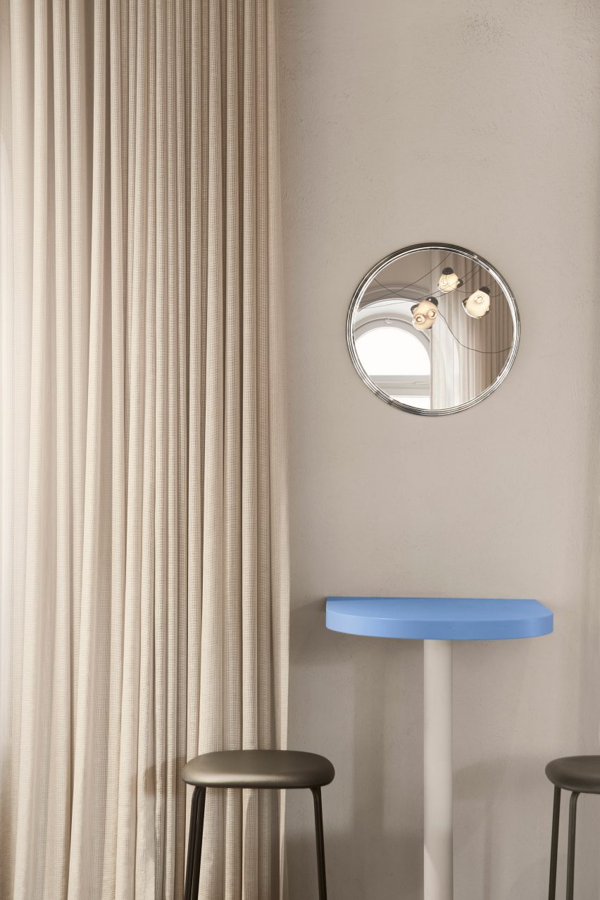 Light blue bar table in neutral-colored interior of restaurant in Stockholm by Note Design Studio