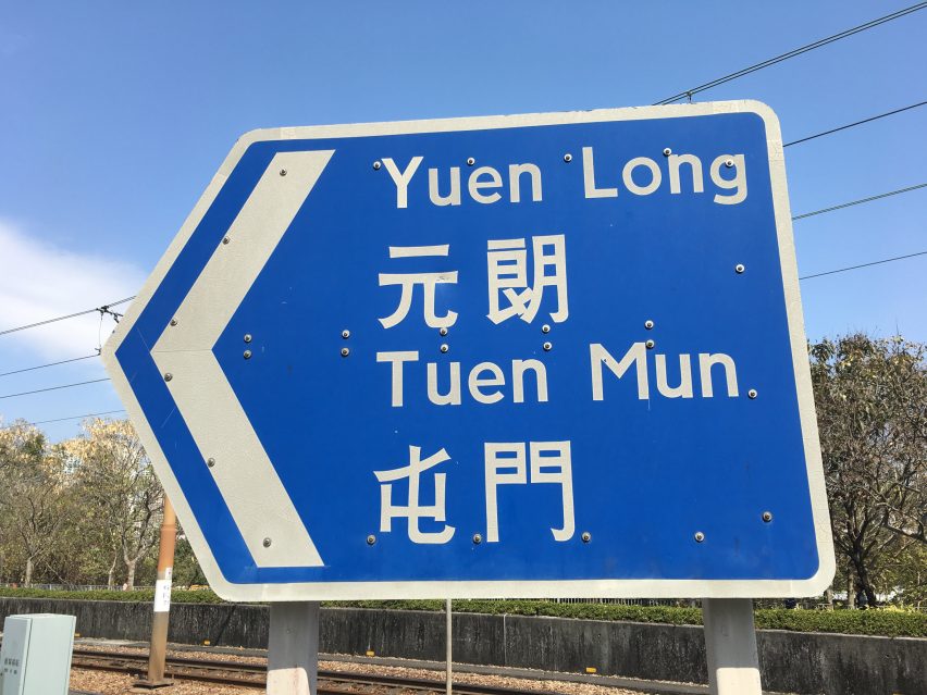 A blue arrowed road sign