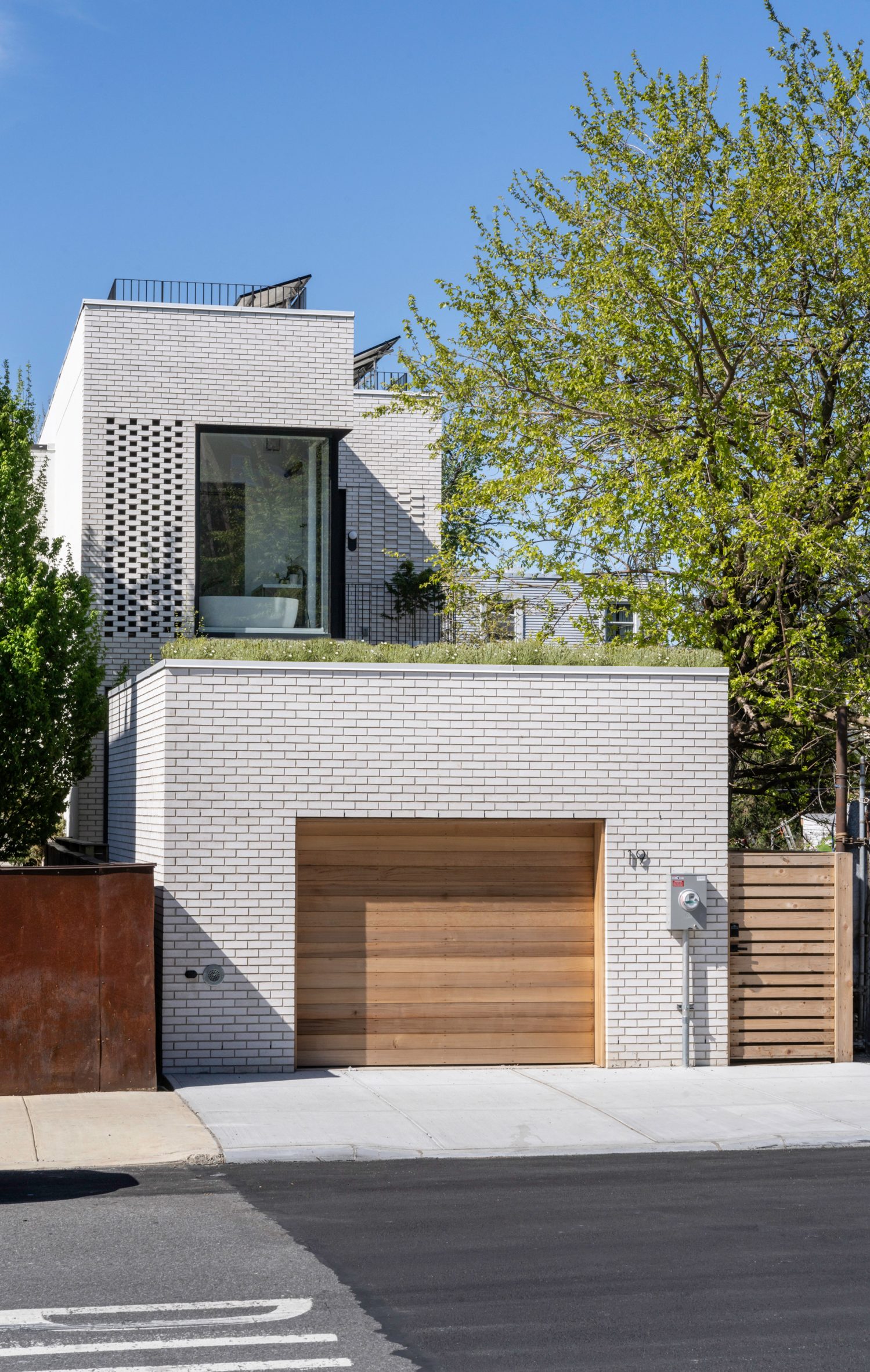 Garage with roof garden in front of white-brick townhouse in New York City