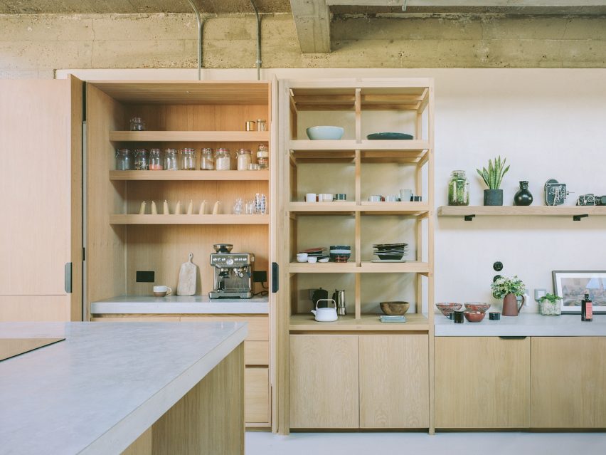 Shelving units next to concrete sideboard in home office by Studio McW