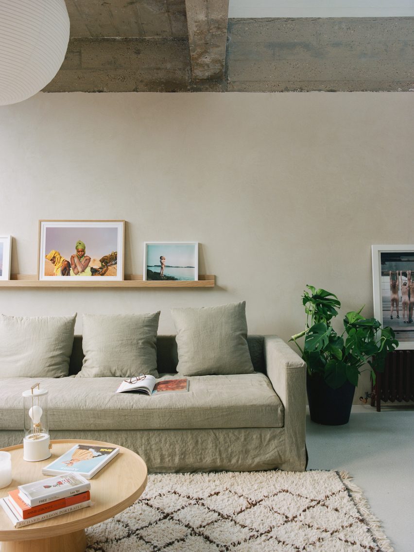 Neutrally toned interior of living space in Hackney with beige sofa and clay-finished walls