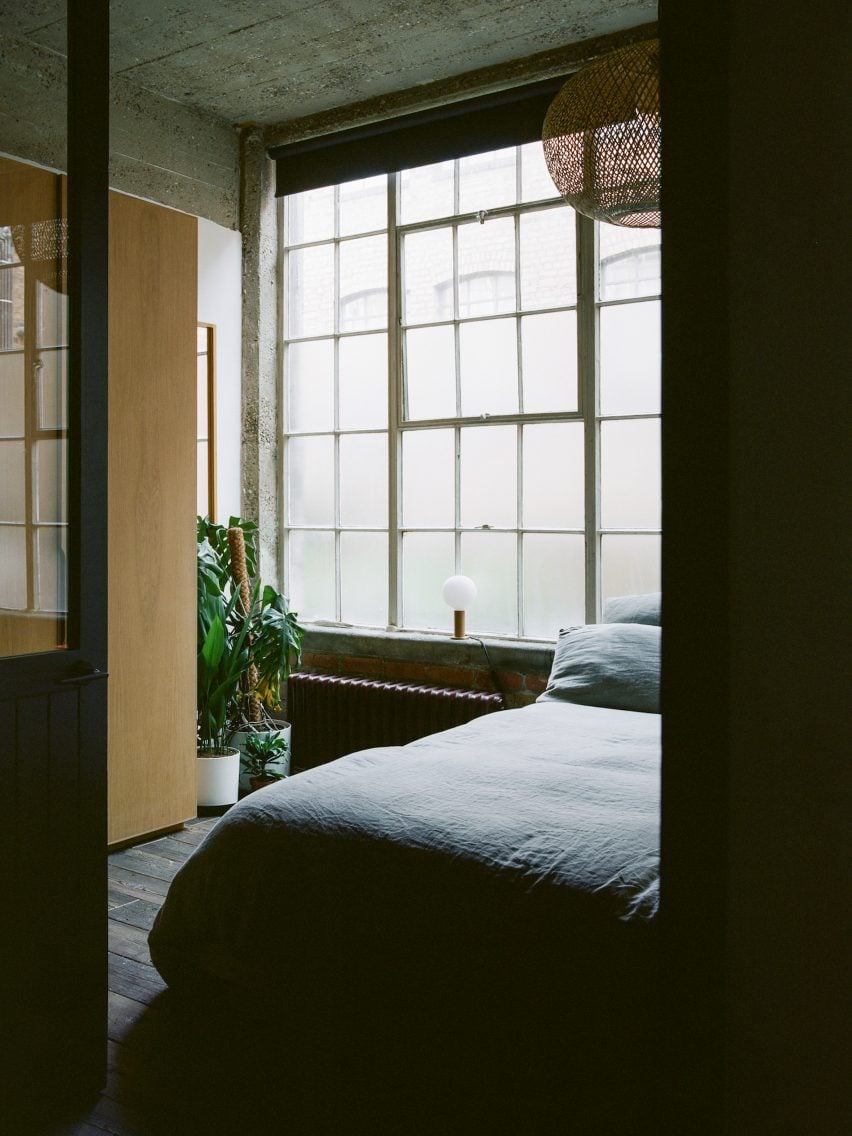 Bedroom with large steel windows designed by Studio McW