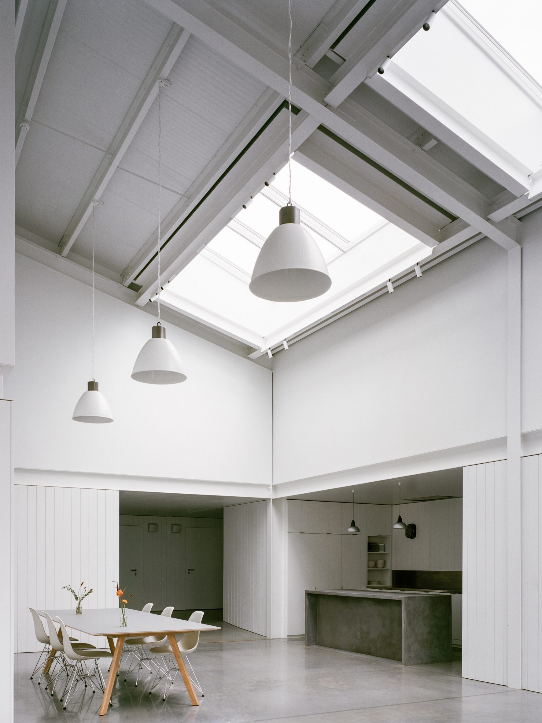 White-hued dining area with skylights in Studio Richter Mahr in Oxfordshire