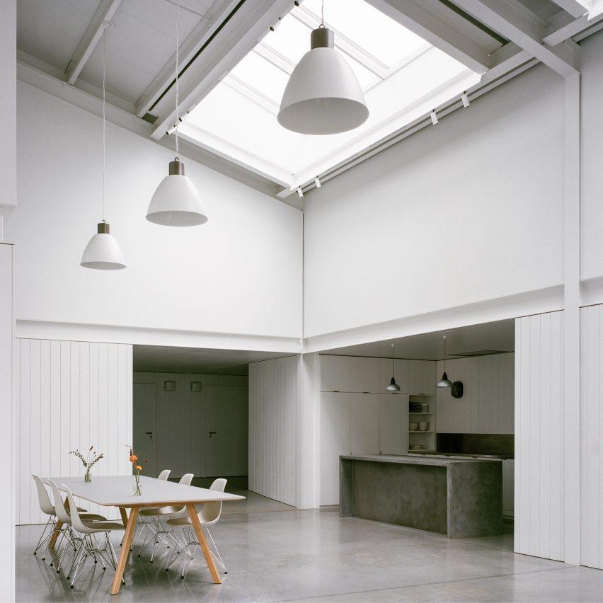 White-hued dining area with skylights in Studio Richter Mahr in Oxfordshire, designed by Charlie Luxton Design