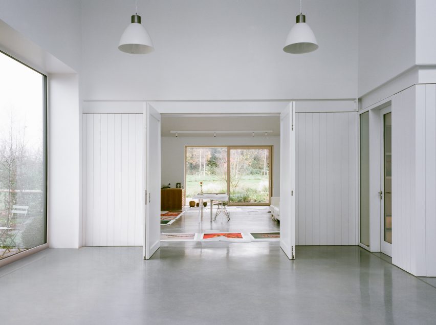 White wood-panelled room in multimedia studio designed by Charlie Luxton Design
