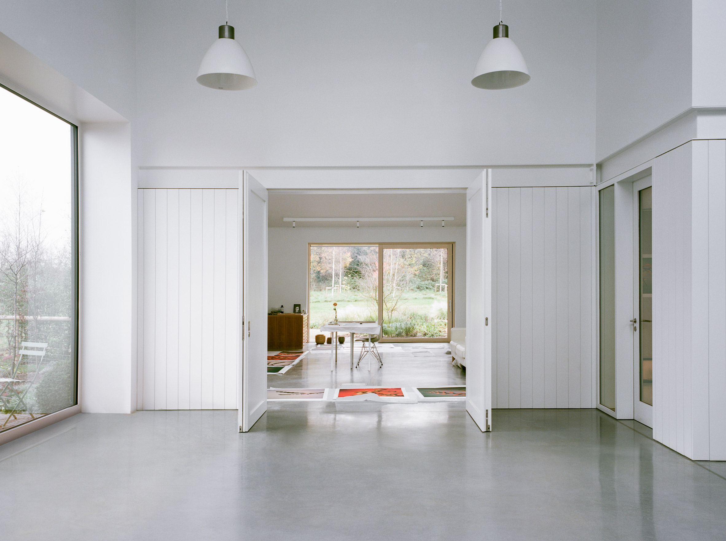White wood-panelled room in multimedia studio designed by Charlie Luxton Design
