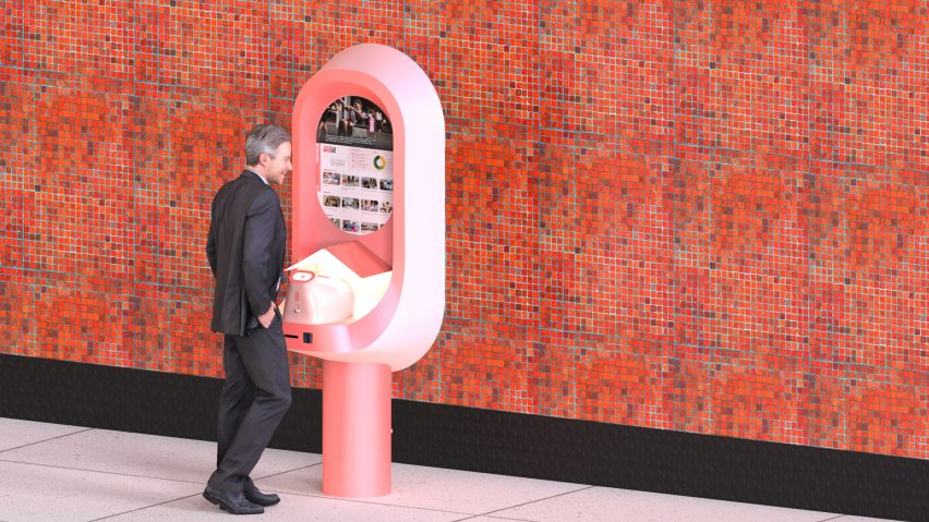 Man stood at a pink device on the pavement against a red-tiled wall