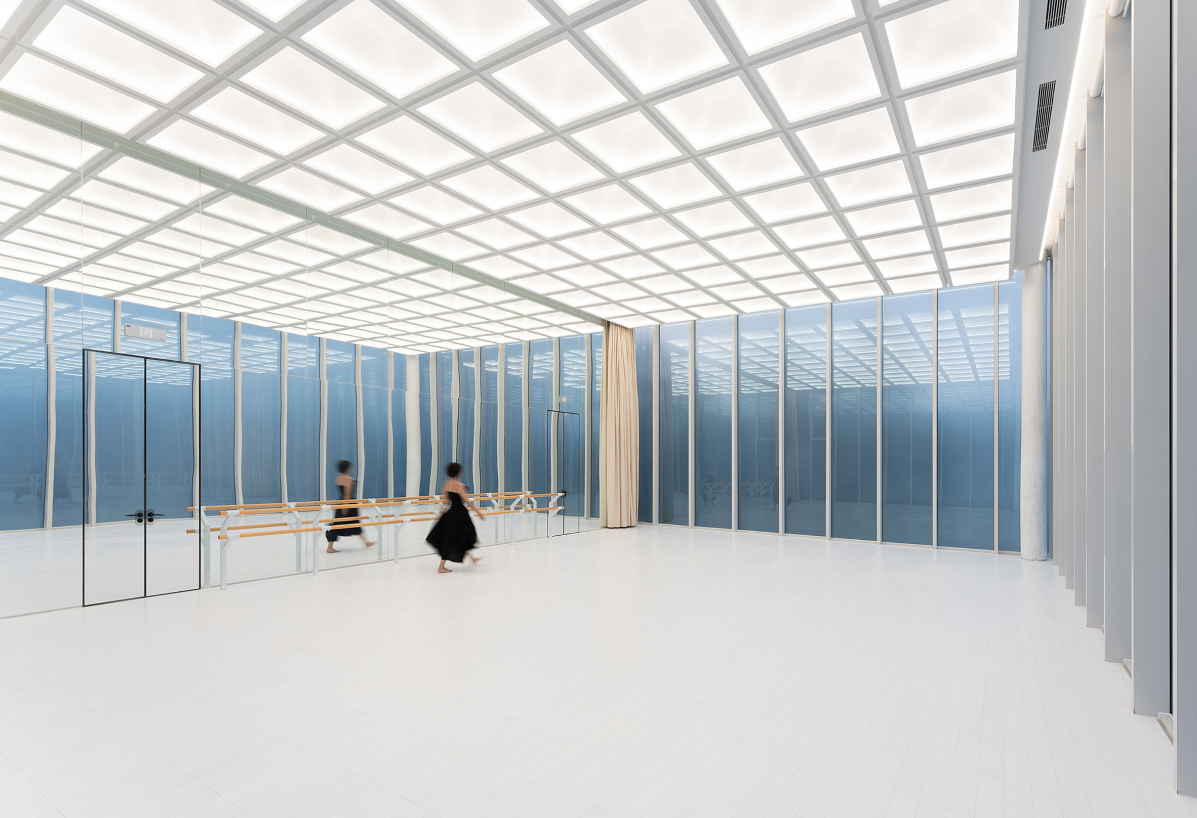 Dance studio with mirrored wall by Wutopia Lab