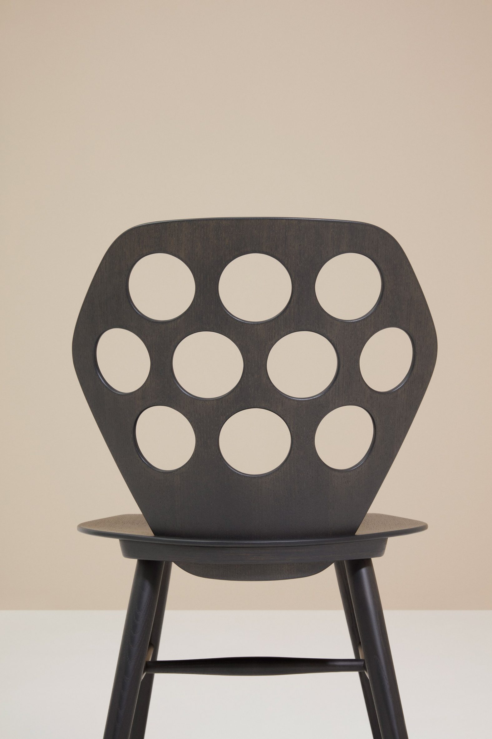 Photograph showing detail of perforated backrest version of chair