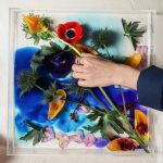 Phot of hand arranging flowers