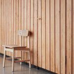 Photo of a chair against a panelled wall