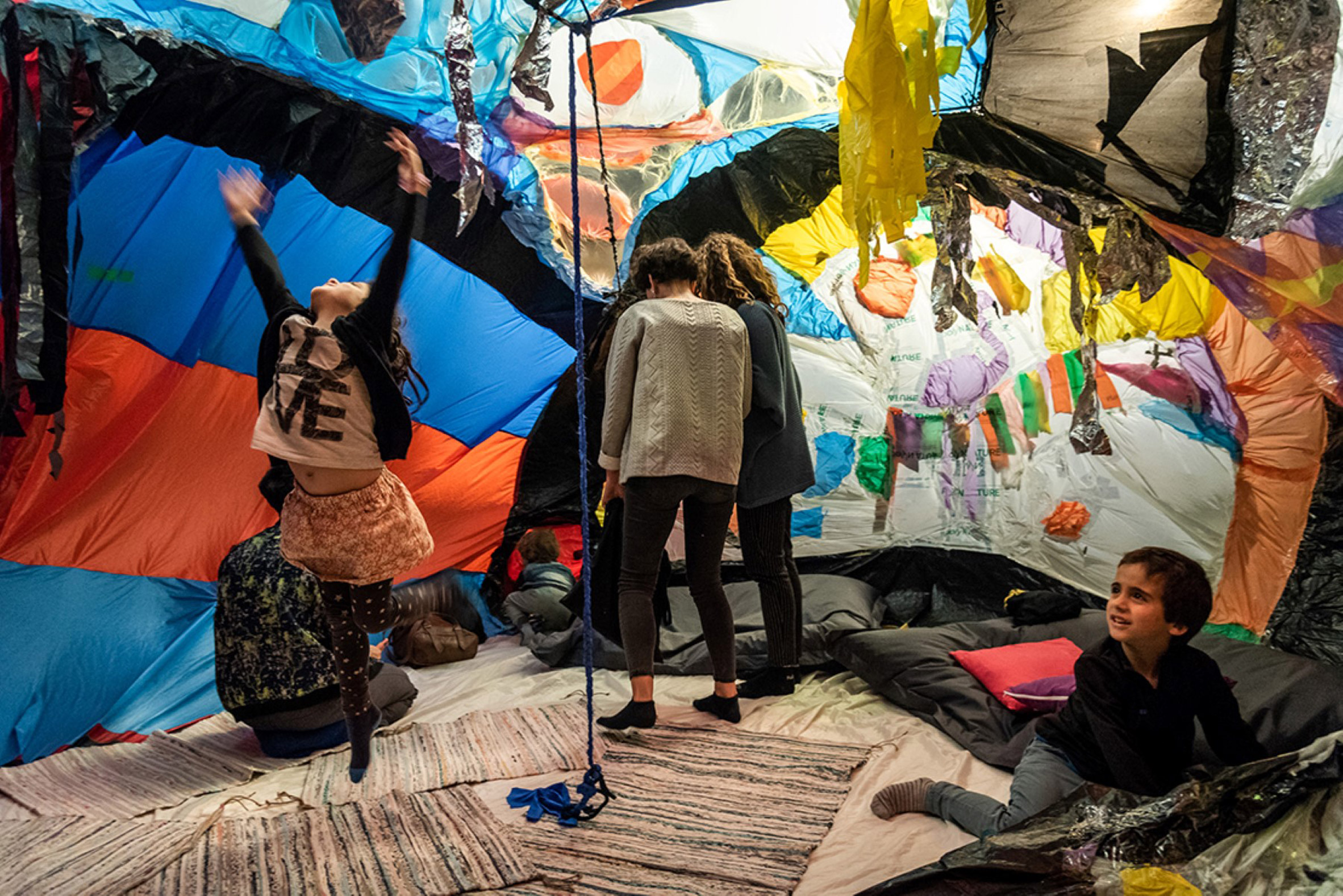 Textile colourful installation with children playing inside