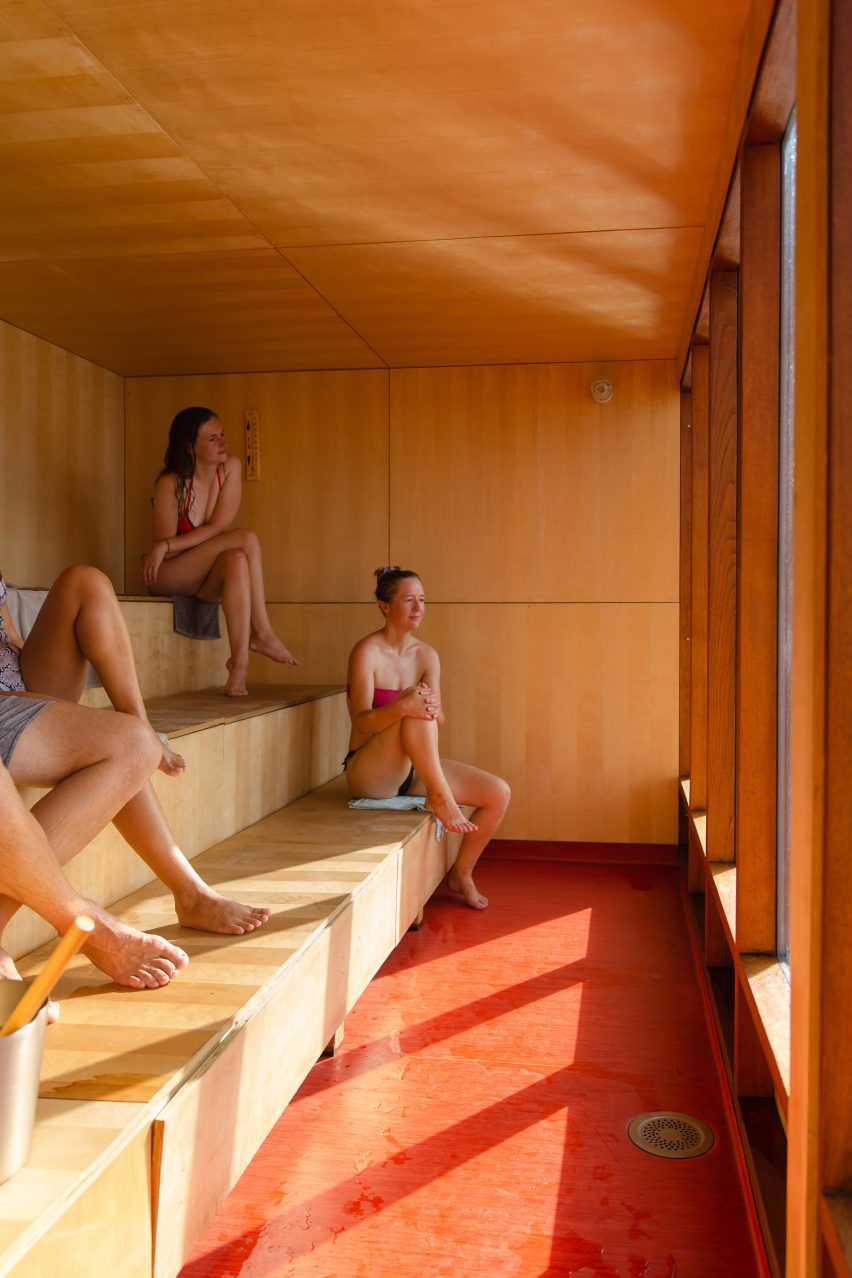Birch plywood-clad sauna with tiered seating and red vinyl floor