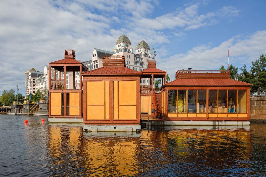 Red and yellow floating sauna with towers in Oslo Harbour