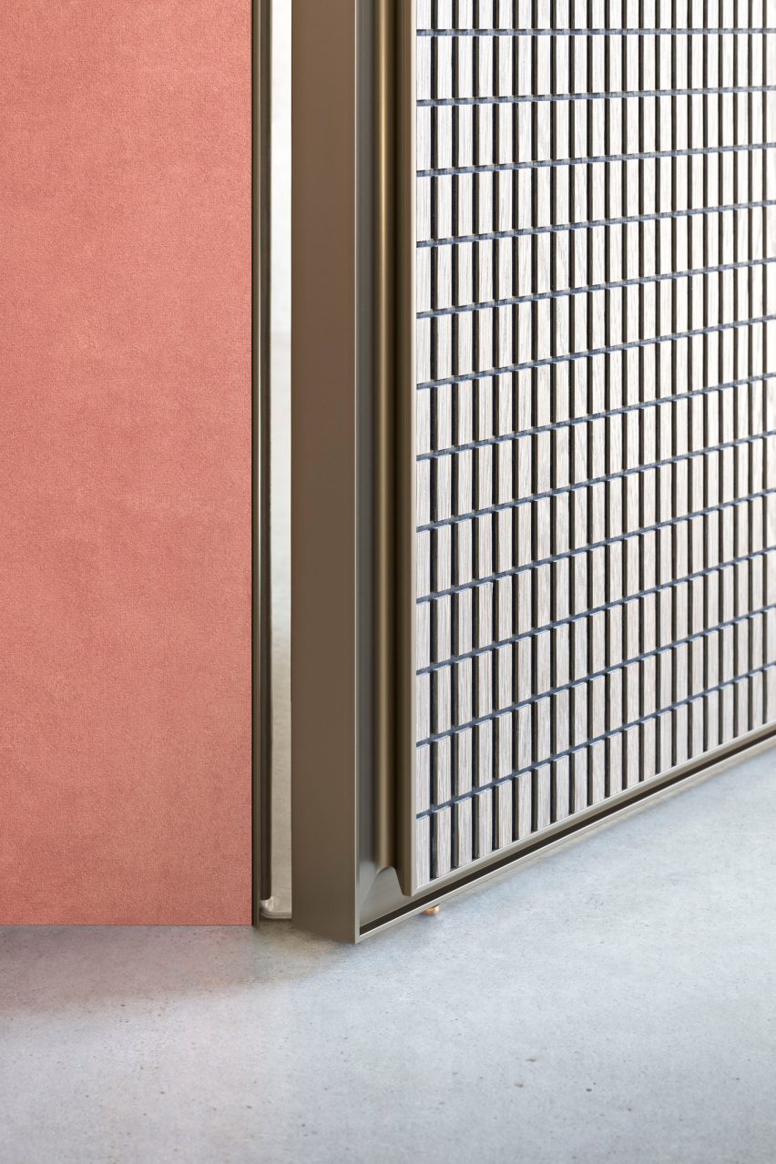 Close-up of the Altaj door with bronze outline and wooden panel carved in a grid pattern