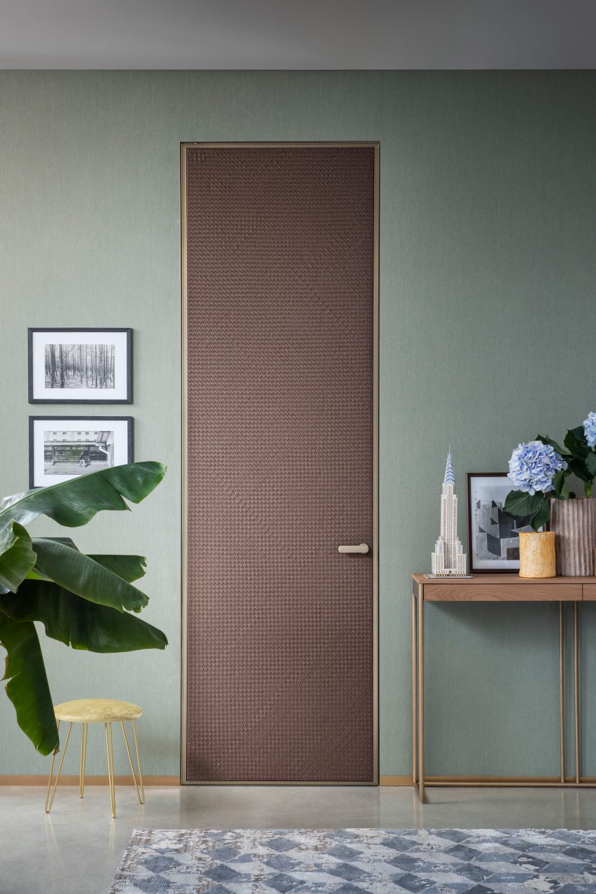 Woven leather door by Lualdi in a teal painted room
