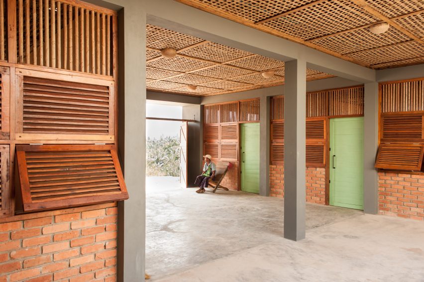 Rooms in Myanmar hospital with green doors and brick walls with timber panels