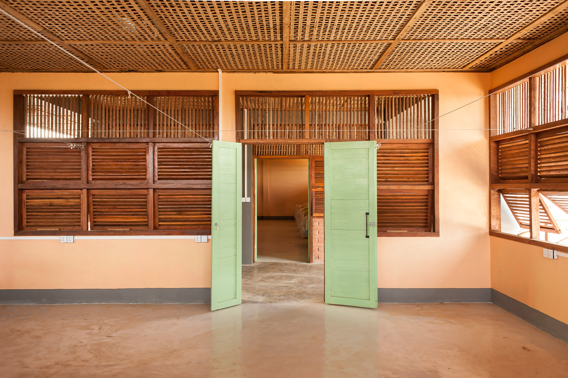 Room with timber and bamboo features and green doors