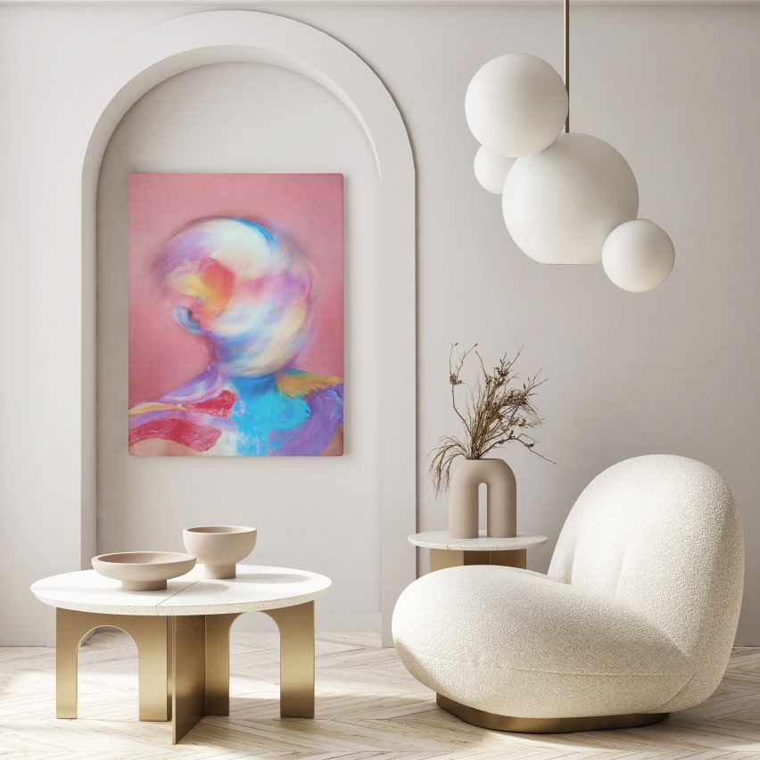 A cream coloured chair in front of an artwork