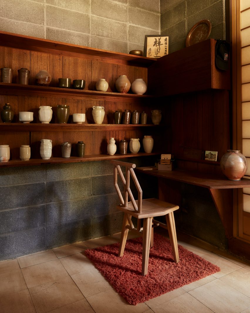 Ceramic pots displayed on wooden shelves