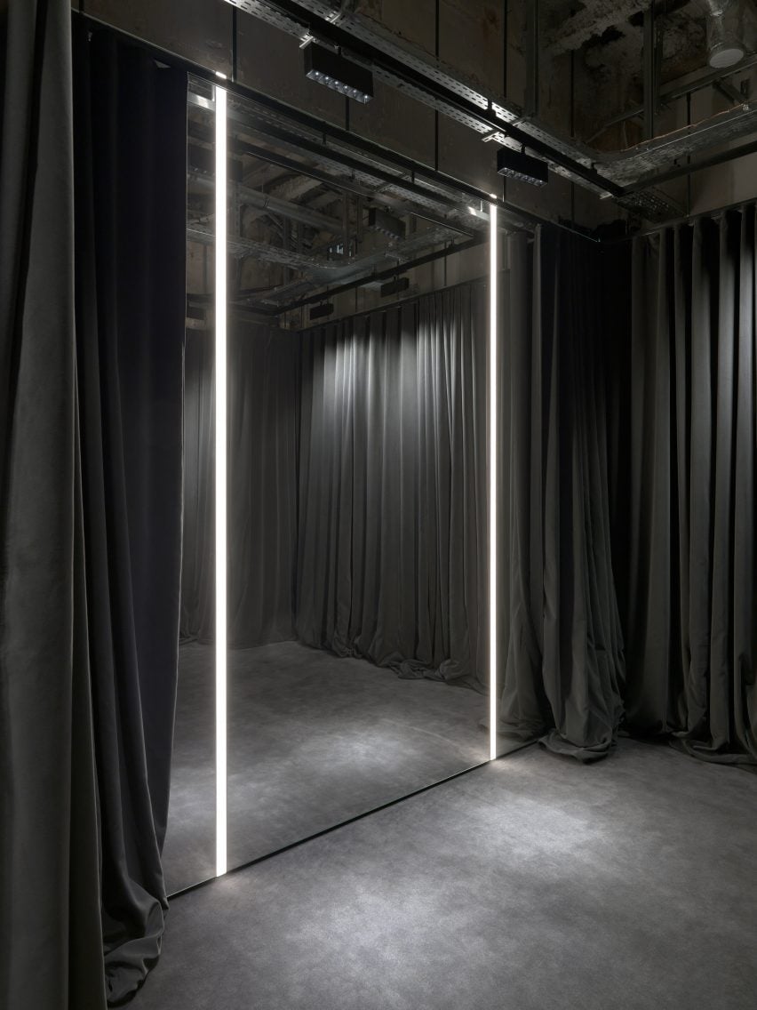 Interior image of a grey-hued fitting room at the Balenciaga Couture Store