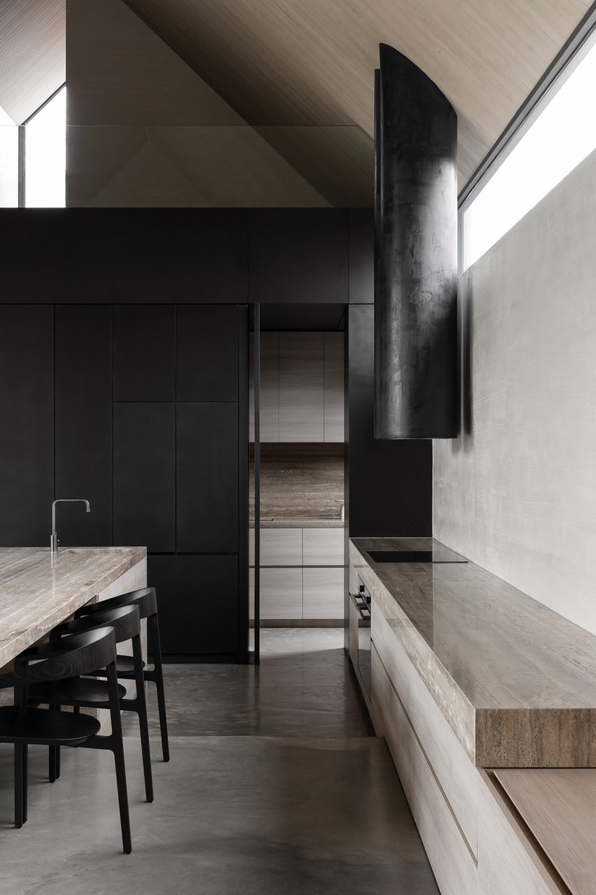 Black kitchen with stone worktops