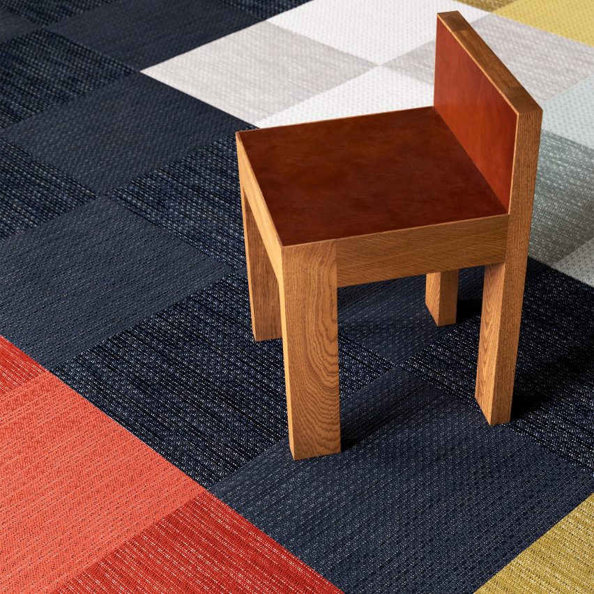 Dark blue, red and cream Bolon carpet tiles with a wooden seat