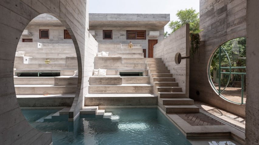 A pool surrounded by grey stone steps