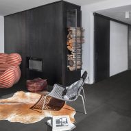 Photograph showing grey-floored living space with cowhide rug