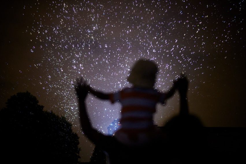 A child watching a firework display by Daan Roosegarde
