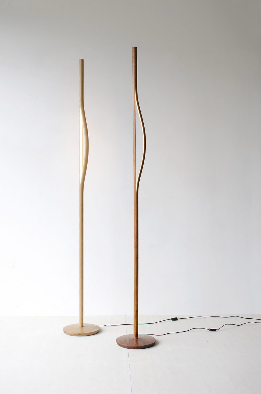 Photograph of two wooden floor lights in a white space