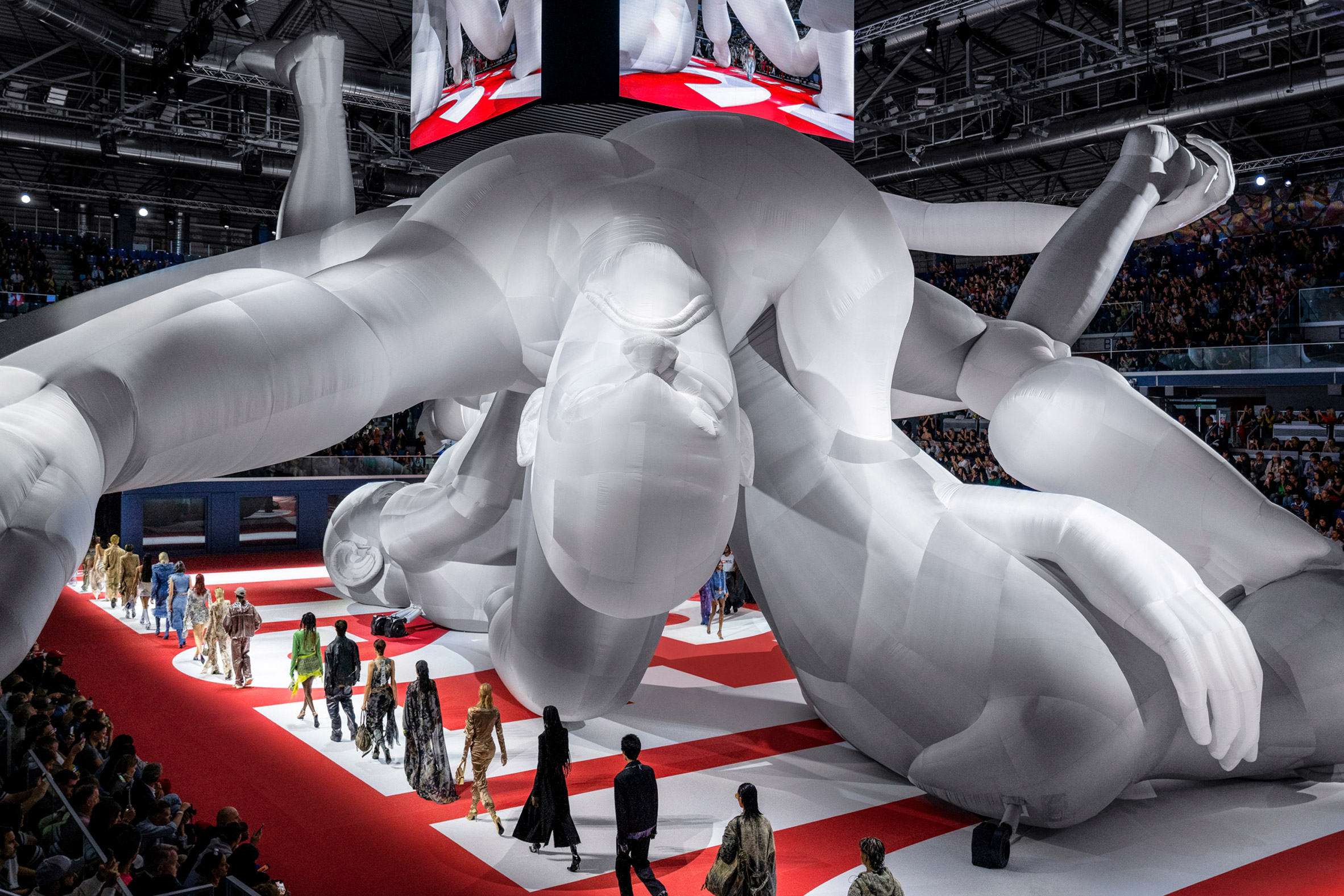 Image of models walking around the World's largest inflatable sculpture at Diesel Spring Summer 2023