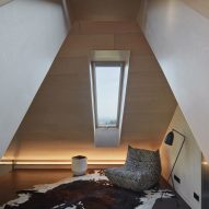 Photograph showing loft room with skylight and chair