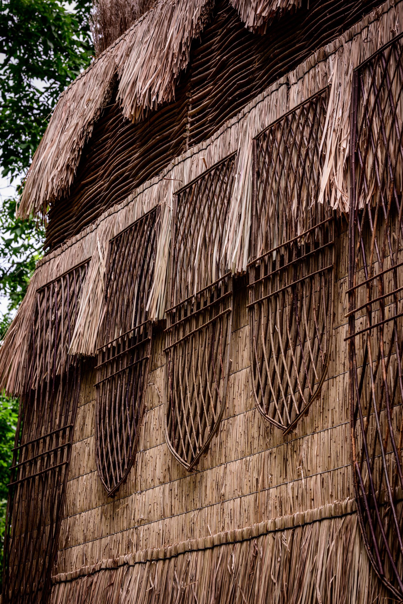 Pavilion walls made from woven hazel branches and reed