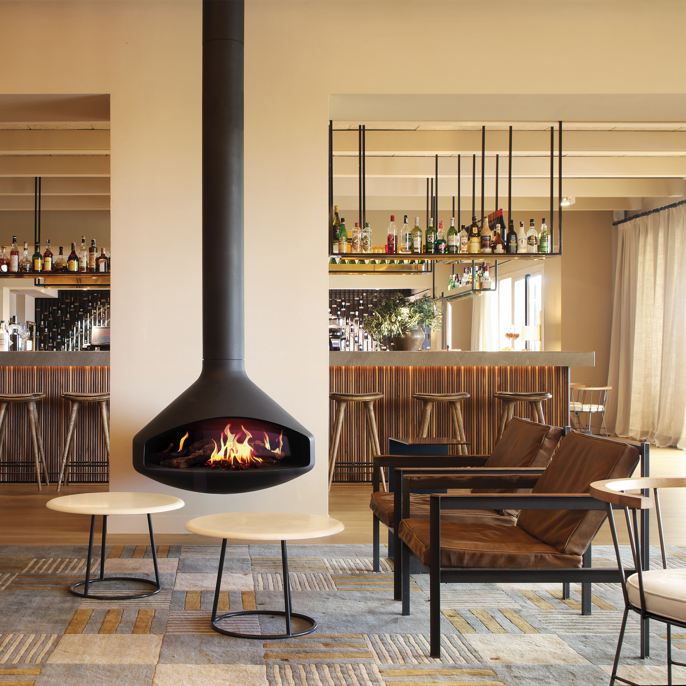 Black modern fireplace in the middle of a cream living space