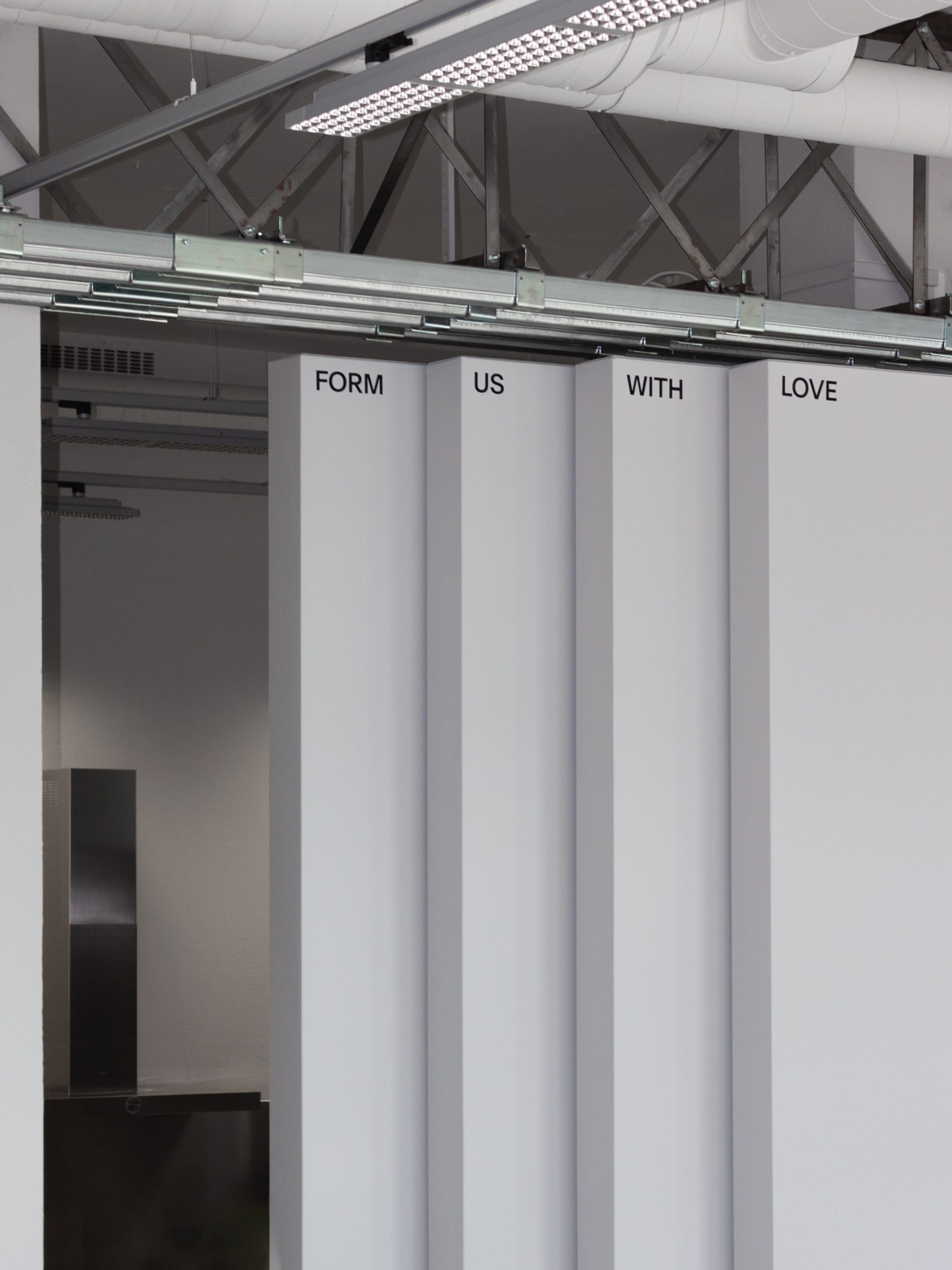 Floor-to-ceiling hangar doors in design studio by Form Us With Love