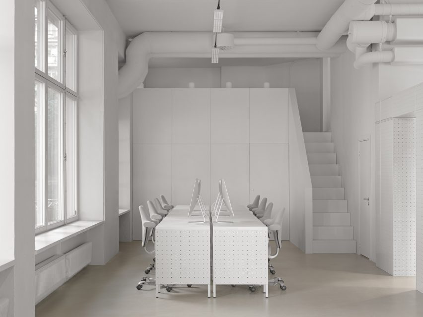 White desks and chairs in white-walled room by Form Us With Love
