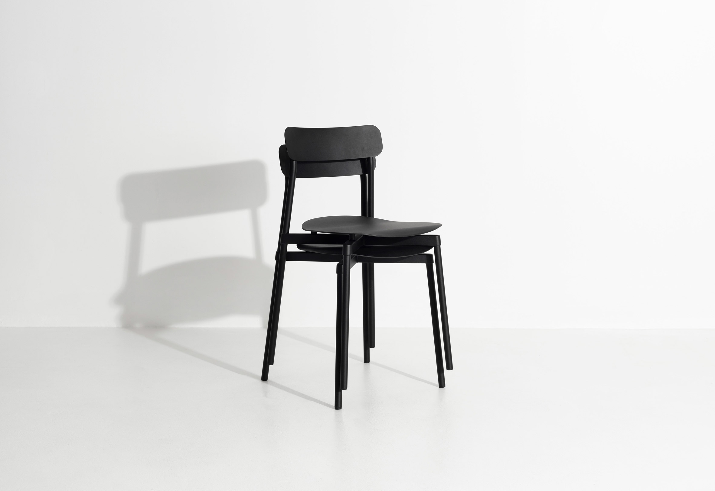 Two black Fromme chairs by Petite Friture stacked