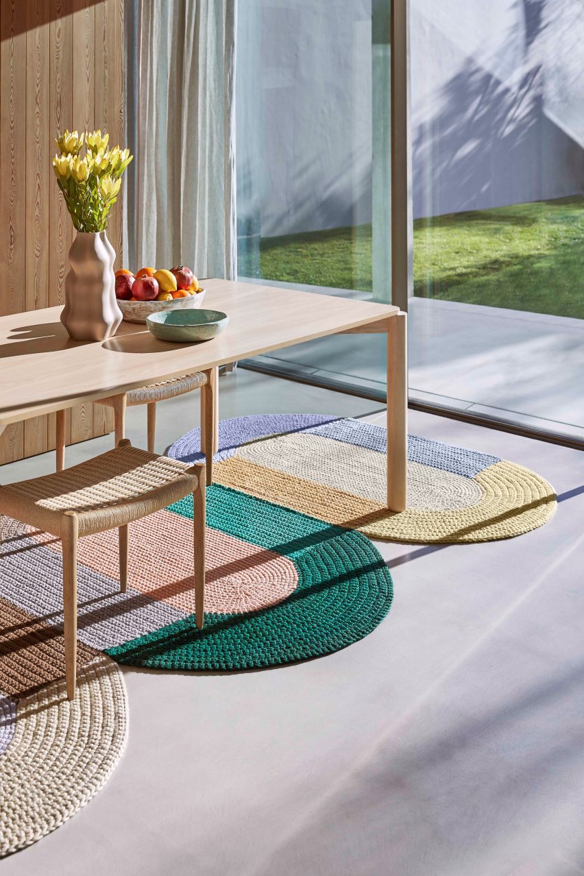 Three Gan crochet rugs in a dining room under a wooden table and chairs