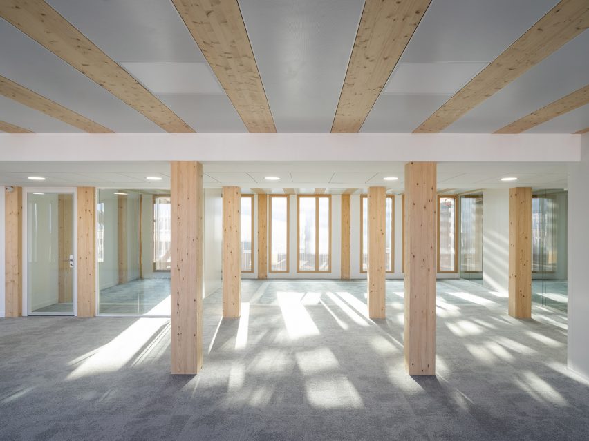 Interior image of a timber column-lined space at the office in France