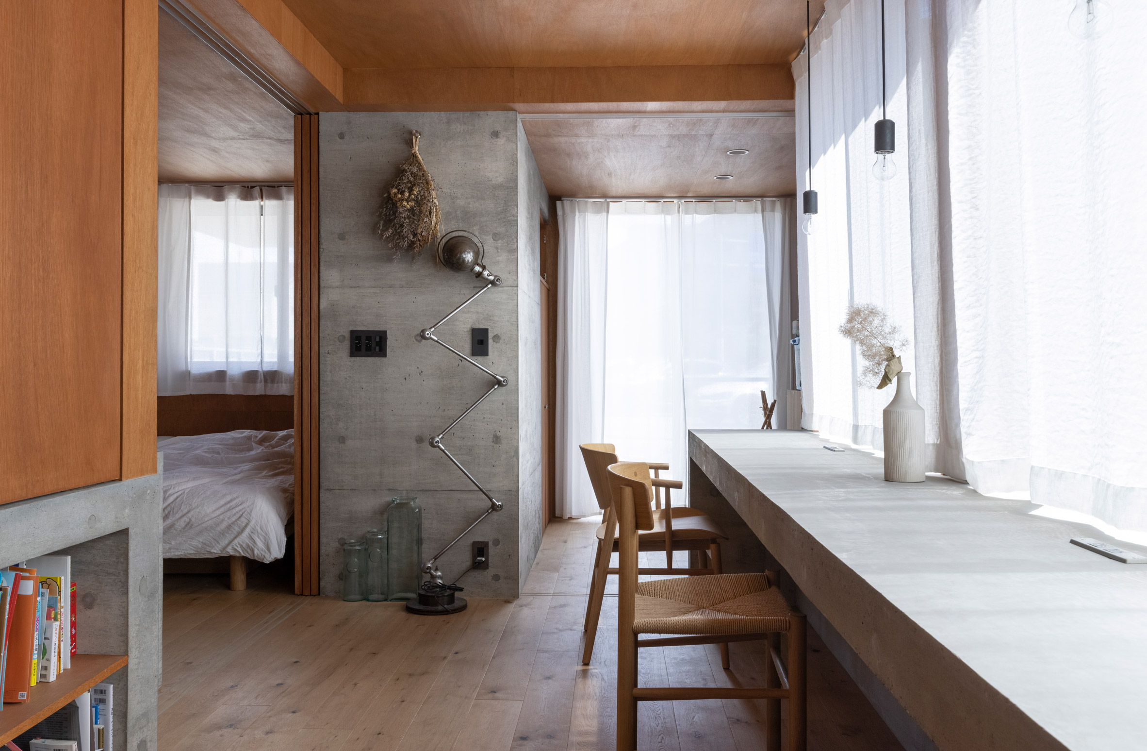 Japanese bedroom with exposed concrete walls and furniture
