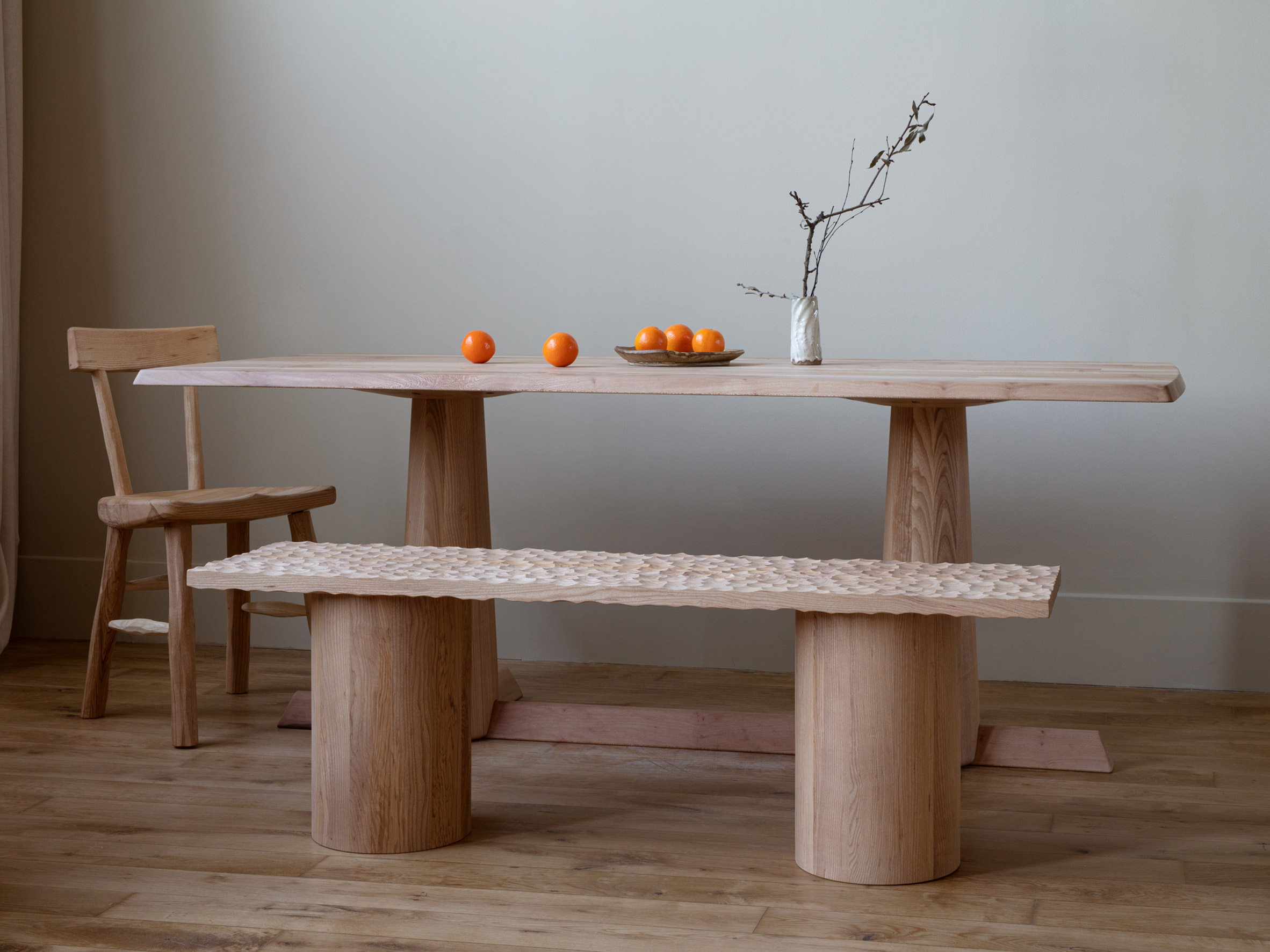 Dining table set up with rippled bench by Jan Hendzel