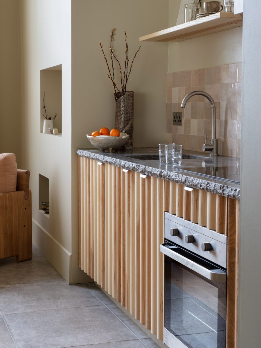 Kitchen with undulating wooden cupboards